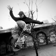 a man riding a skateboard up the side of a tree