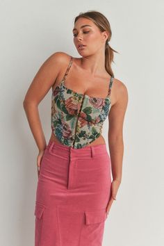 Look stunning this season with our Multi Color Flower Print Corset Top. Made of lightweight polyester fabric, it features a corset-style bodice and an allover floral print. The top cinches in the waist and emphasizes curves, creating an elegant silhouette. Make sure to turn heads at any special occasion. Fabric & fit: Model is wearing size Small. Floral Print Underbust Corset, Summer Floral Print Corset With Fitted Bodice, Floral Print Overbust Corset With Fitted Bodice, Floral Print Fitted Corset, Summer Floral Corset, Floral Print Fitted Sleeveless Corset, Summer Fitted Floral Print Corset, Chic Floral Print Corset For Summer, Chic Sleeveless Floral Print Corset