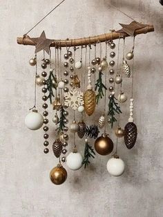 a wind chime with ornaments hanging from it's sides and pine cones on top