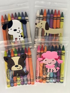 two clear bags filled with different colored crayons and some animals on top of them