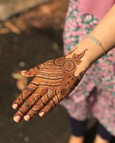 a woman's hand with henna on it