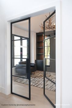 an open glass door leading to a living room