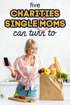 a woman holding a smart phone in front of a bag full of vegetables and fruits