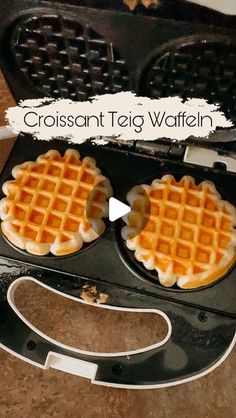 two waffles sitting in an open waffle iron with the words, crossant teg wafflen