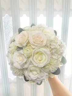 a person holding a bouquet of white flowers