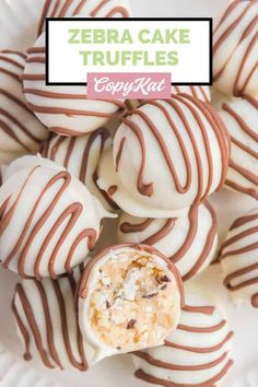 zebra cake truffles on a white plate with chocolate drizzle