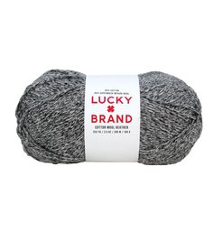 a ball of gray yarn with the words lucky brand on it in red and white