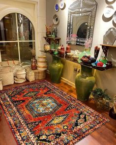 a room filled with lots of vases and rugs