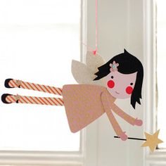 an ornament hanging from the side of a door with a girl on it