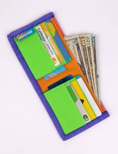 This rad wallet is the perfect place to keep all of your money related objects! Features 6 front-facing credit card slots with 2 extra hidden slots, a main cash pocket, color block detailing, and nylon binding. Shop all WalletsShop all Dragonfly Measures 9" wide x 4" tall unfolded, 4.5" wide folded.Water resistant 100% Coated Nylon Made in Los Angeles, California Everyday Multicolor Bifold Wallet, Green Rfid Blocking Trifold Wallet For Travel, Green Trifold Wallet With Rfid Blocking For Daily Use, Multicolor Bifold Wallet For Everyday Use, Multicolor Rfid Blocking Wallets For Daily Use, Multicolor Bifold Wallet With Interior Card Slots, Green Trifold Wallet With Rfid Blocking, Retro Multicolor Travel Wallet, Multicolor Trifold Wallet With Card Slots For Daily Use