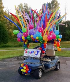 a golf cart decorated with balloons and streamers