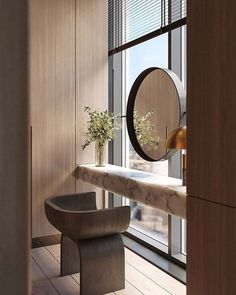 an empty room with a bench, mirror and vase on the window sill in front of it