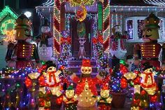 christmas lights decorate houses and lawns with holiday decorations on the front yard, including snowmen