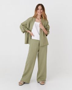 This throw-on linen kimono jacket BANOS in sage offers an effortlessly chic look with its open front, shawl collar, and relaxed dropped shoulders. The 3/4 sleeves feature decorative flaps at the bottom, which can be secured with coconut buttons, adding a unique touch to the design. Details: * Loose fit * Shawl collar * Non-closable * 3/4 sleeve length * Dropped shoulder design * Bottom of the sleeves that fastens with decorative coconut buttons * Centre back length: 23" (58cm) * The model is wea Summer Green Linen Blazer, Casual Linen Kimono With Relaxed Fit, Spring Green Linen Blazer, Green Linen Summer Outerwear, Spring Casual Linen Kimono, Casual Linen Kimono For Spring, Green Linen Spring Outerwear, Spring Green Linen Outerwear, Linen Kimono