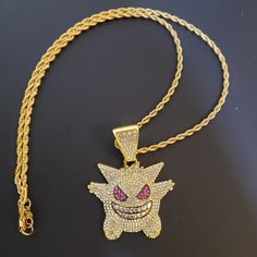 Hey thanks for looking! Listing is for a faux diamond crusted Gengar chain, comes with the chain and pendant Shipping is free! Gold Plated Rhinestone Necklace With Adjustable Chain, Rhinestone Pendant Necklace With Adjustable Chain, Adjustable Metal Rhinestone Pendant Necklace, Iced Out Metal Pendant Jewelry, Gold Iced Out Jewelry For Party, Iced Out Metal Chain Necklace For Gifts, Gift Metal Chain Necklace Iced Out, Gift Metal Chain Necklace With Iced Out Details, Gold Rhinestone Costume Jewelry