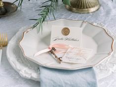 a table setting with place cards, napkins and silverware on it's plate