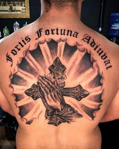 a man with a cross tattoo on his back