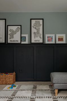 a living room with pictures on the wall and a couch in front of some baskets