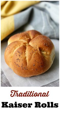 a close up of a bread roll on a piece of paper with the words traditional kaiserer rolls