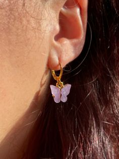 These dainty gold butterfly earrings are one of our best selling items! Perfect for summer, these lightweight earrings will be your new go-to! Our Butterfly Earrings are totally customizable! You can choose silver or gold outline AND the color of the pearl wings! The available colors can be seen in our options box ~ ~ Wear alone or stack these earrings for a cute look~  ~ Light weight and made personalized because we care about sensitive ears! Style of Earrings offered: ~ Regular: made to order with gold plated huggie earrings (hoop style earring wither lever backing). ~ 18K Hook: made to order with 18K gold plated ear wire hooks ~ Stainless Steel/Gold: made to order with stainless steel or stainless gold huggies to match the charm!~ This listing is for one (1) pair of Earrings! 🔮Crystals Dainty Pink Hoop Earrings, Trendy Butterfly Hoop Earrings As Gift, Trendy Hoop Earrings With Butterfly Charm As Gift, Dainty Butterfly Charm Earrings, Spring Butterfly Charm Jewelry Gift, Spring Gold Jewelry With Butterfly Charm, Butterfly Charm Hoop Earrings As Gift, Dainty Butterfly Earrings For Everyday Wear, Dainty Hoop Earrings With Butterfly Charm