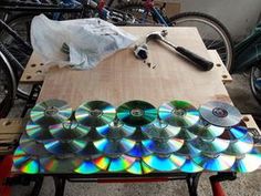 several cds are sitting on a table next to bicycles