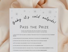 a baby it's cold outside pass the prize card on top of a blanket