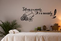 there is a wall decal that says self care is priority it's a necessary