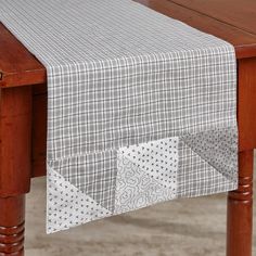 Add a farmhouse charm to your home with this patch cream and gray plaid table runner. To style this beautiful rectangular table runner, simply extend the item along the length of the desired surface. This timeless covering is perfect for everyday or formal use and will protect your surfaces from daily wear and tear.