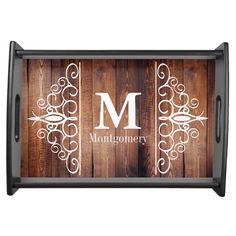 a wooden tray with the letter m on it and an ornate monogrammed design