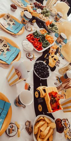 the table is set up with plates, cups, and other food items for a children's birthday party