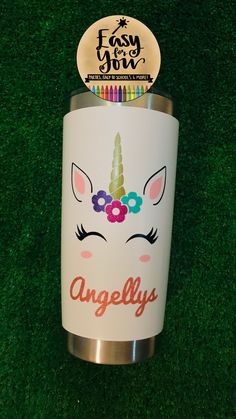 a white cup with an unicorn face on it and the words angelly's