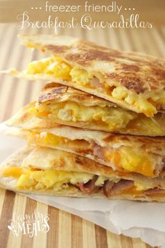 three breakfast quesadillas stacked on top of each other with the words freezer friendly breakfast quesadillas