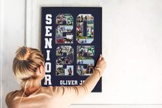 a woman is holding up a sign with photos on it that says senior 50 years