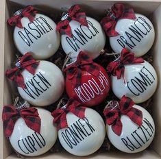 twelve ceramic ornaments in a box with red and black bows on them, saying good to someone