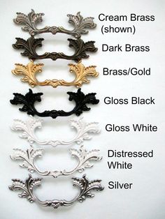 four different types of hair clips with names on them, all in gold, silver, and black