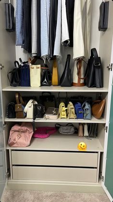 an organized closet with handbags and purses