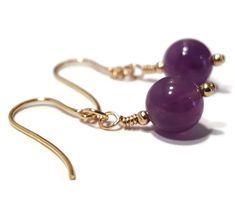 Earring details: - amethyst beads are 8mm - hook earrings are 9ct gold - 2mm 9ct gold beads - total length is 36mm 9ct Gold Amethyst Earrings These gorgeous earrings feature amazing purple amethyst round gemstone beads that are set with gold beads. The gold earrings are hook fastening with safety backs to secure them. Amethyst has always been linked to the thinking process, ensuring clarity of vision. It inspires creativity, courage and valour. Amethyst's purple colour made it a stone of royalty for many thousands of years. Please see our other items in our Shop: https://www.etsy.com/uk/shop/TheJoyOfJewels *Free Complimentary Gift Box* Your jewellery will arrive in a beautiful gift box, carefully packaged for a safe arrival and ready for gifting to a loved one or to yourself. If you have a Purple Gemstone Bead Dangle Earrings, Purple Gemstone Beads Dangle Earrings, Purple Dangle Earrings With Gemstone Beads, Purple Gemstone Round Bead Earrings, Purple Gemstone Earrings With Round Beads, Adjustable Purple Jewelry With Lever Back Ear Wires, Purple Amethyst Earrings, Thinking Process, Red Coral Earrings