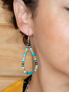 Crafted with natural elements, the Spiny Oyster & Turquoise Beaded Earrings capture the hues of the southwest's rusted earth and vibrant turquoise skies. Embellished with handmade sterling silver Navajo pearls, these orange spiny oyster and turquoise beaded hoop earrings transition seamlessly from day to night. Elevate your fashion with our entire collection of matching spiny oyster jewelry. Sterling Silver Navajo Pearls with 4mm Turquoise and 4mm Spiny Oyster Beads and Sterling Silver Hooks. Le Turquoise Teardrop Beaded Earrings For Festival, Southwestern Turquoise Earrings With Colorful Beads, Southwestern Teardrop Beaded Earrings, Southwestern Teardrop Jewelry With Colorful Beads, Bohemian Drop Earrings With Polished Beads, Southwestern Teardrop Jewelry For Festivals, Bohemian Polished Beads Turquoise Earrings, Artisan Turquoise Beaded Hand-strung Earrings, Artisan Turquoise Beaded Earrings