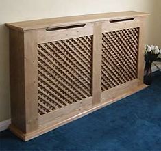 a large wooden cabinet sitting next to a blue carpeted floor in a living room