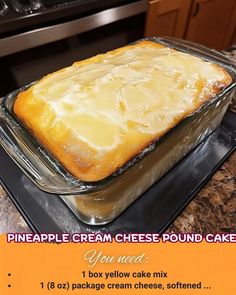 a cake in a pan sitting on top of a stove next to a sign that says pineapple cream cheese pound cake