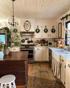 the kitchen is decorated with wreaths and other holiday decorations, including wreaths hanging from the ceiling