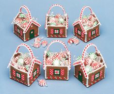 six christmas baskets with candy canes and candies in them on a blue background