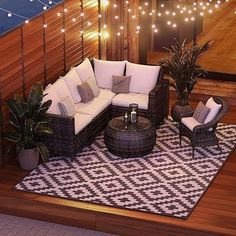 an outdoor patio with furniture and lights