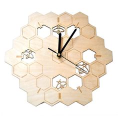 a clock made out of wooden pieces with numbers on each side and hands in the shape of hexagons