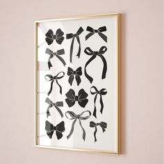 a framed black and white photo with bows on it's side, hanging on the wall