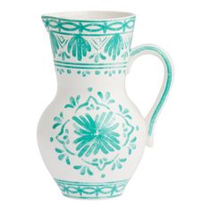 a green and white vase with designs on the bottom, sitting against a white background