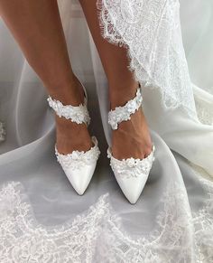 Ladies white bridal shoes with white floral lace trim, Classic and chic wedding pumps, minimal design makes a statement with simplicity. They feature a stylish pointed toe, lightly cushioned leather insole and a flattering ankle side strap. Crafted from the finest wedding materials in pearlized white with a wrapped low block heel. This timeless Bridal shoe is meant to be enjoyed long after your special day To view our entire collection of wedding sandals and shoes please visit the following link Unusual Wedding Shoes, Flat Bridal Shoes, White Bridal Shoes, Bridal Shoe, Bridal Flats, Wedding Pumps, Heels White, Bridal Shoes Flats, White Wedding Shoes