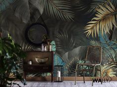 a chair and table in front of a wall with tropical leaves painted on the walls