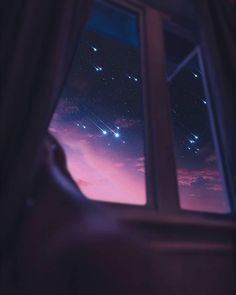 the sky is filled with stars as seen through a window