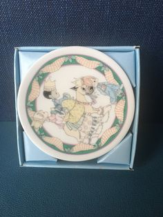 a porcelain plate with an image of two dogs on it's side in a blue box